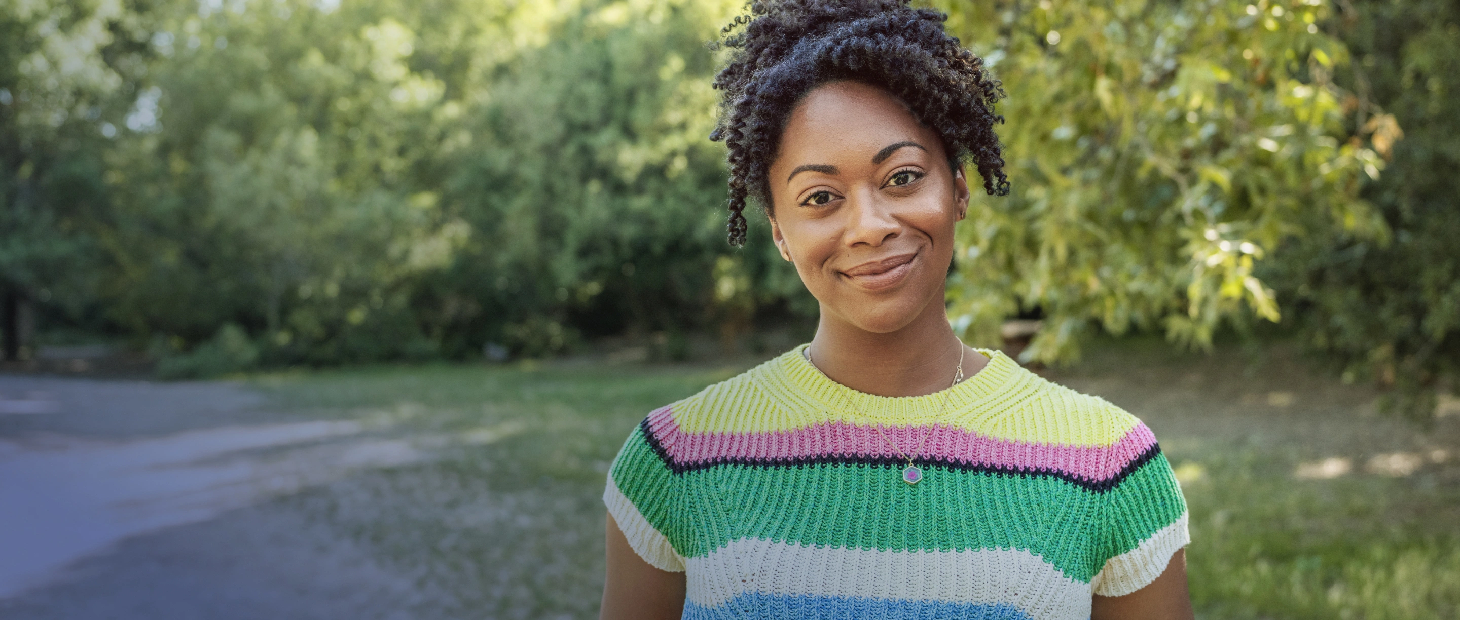 Actor portrayal of a smiling woman.